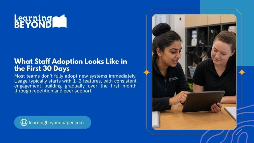 Two childcare staff members review a tablet together, illustrating what staff adoption looks like in the first 30 days of a new digital system.